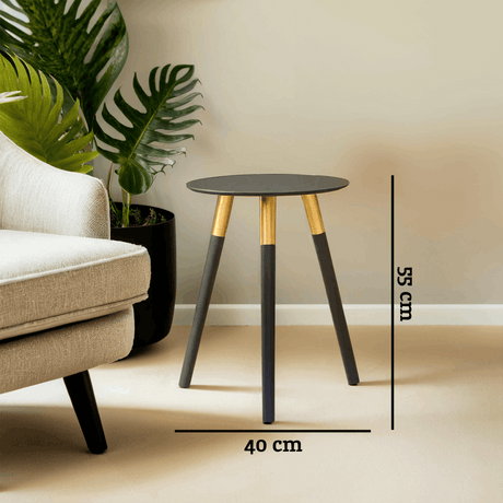 Orsina Side Table with a sleek black top and gold legs, perfect for modern living spaces