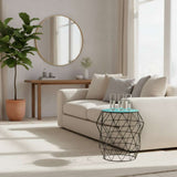 Modern Orsina Side Table with Geometric Design and Glass Top beside a comfortable sofa in a bright living room