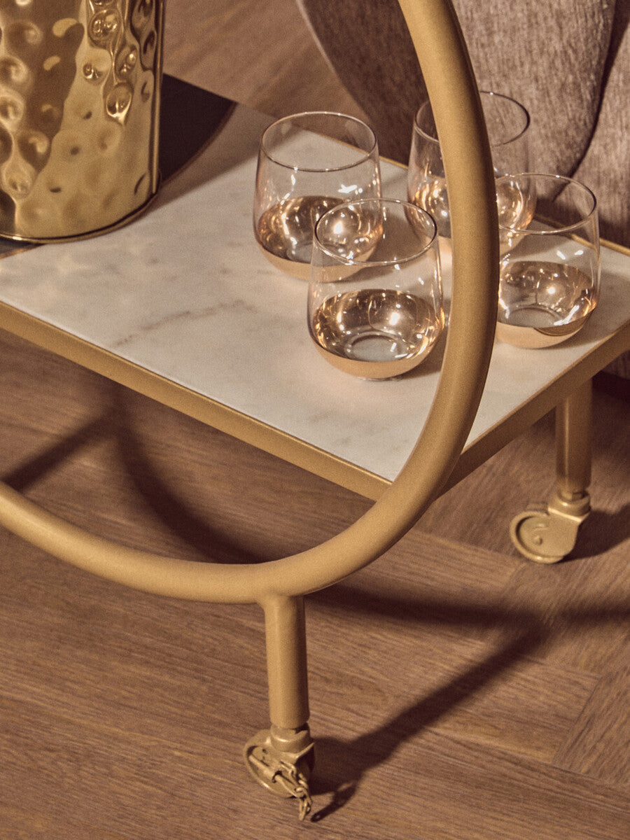 Orsina Side Table with Gold Frame and Marble Top, featuring elegant glasses on the surface
