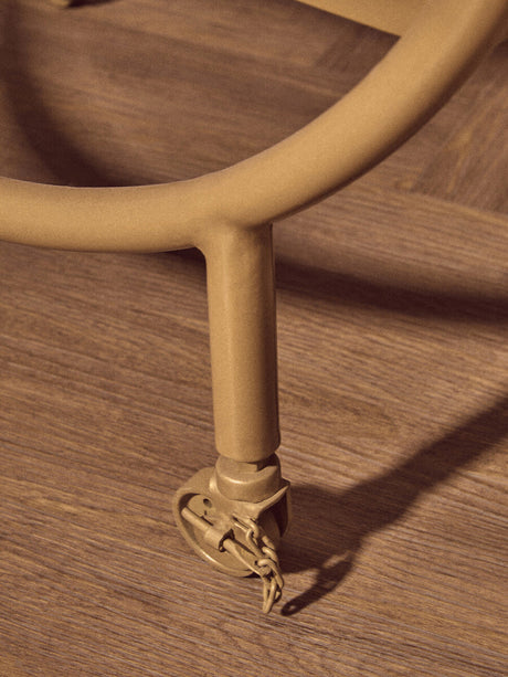 Orsina Side Table featuring sturdy wheels for easy mobility and a modern design