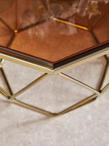 Orsina Side Table with a geometric gold base and a stylish glass top