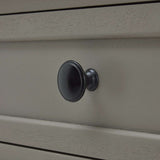 Close-up of a black knob on a Shades 4 Seasons side table with a smooth finish