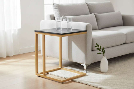 Orsina side table with a black top and gold metal frame, perfect beside a modern sofa