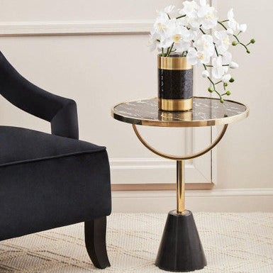 Elegant Orsina Side Table with a marble top and gold accents, complementing a stylish chair