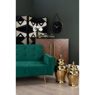 Stylish Orsina Drinks Cabinet in herringbone pattern with gold handles, alongside green sofa and decorative accessories