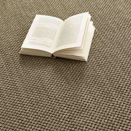 Sisal Rug in a natural beige colour with a book open on the textured surface