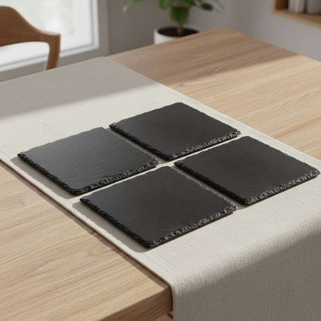 Selbrae House Slate Gift Set with four elegant slate coasters on a wooden table