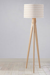 Stylish wooden floor lamp with a geometric patterned lampshade from Shadow bright