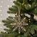 Shades 4 Seasons Snowflake Decoration hanging on a Christmas tree with soft lighting