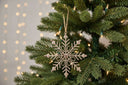 Shades 4 Seasons Snowflake Decoration hanging on a Christmas tree with soft lighting
