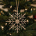 Shades 4 Seasons Snowflake Decoration hanging from a Christmas tree with festive lights