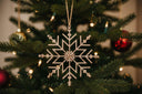 Shades 4 Seasons Snowflake Decoration hanging from a Christmas tree with festive lights