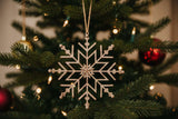 Shades 4 Seasons Snowflake Decoration hanging from a Christmas tree with festive lights