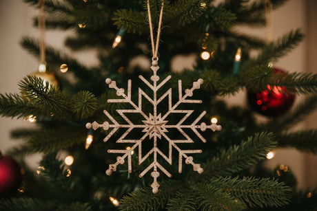 Shades 4 Seasons Snowflake Decoration hanging from a Christmas tree with festive lights