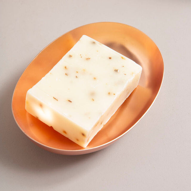 Orsina Soap Dish in Copper Finish with a Natural Soap Bar on a Minimalist Surface