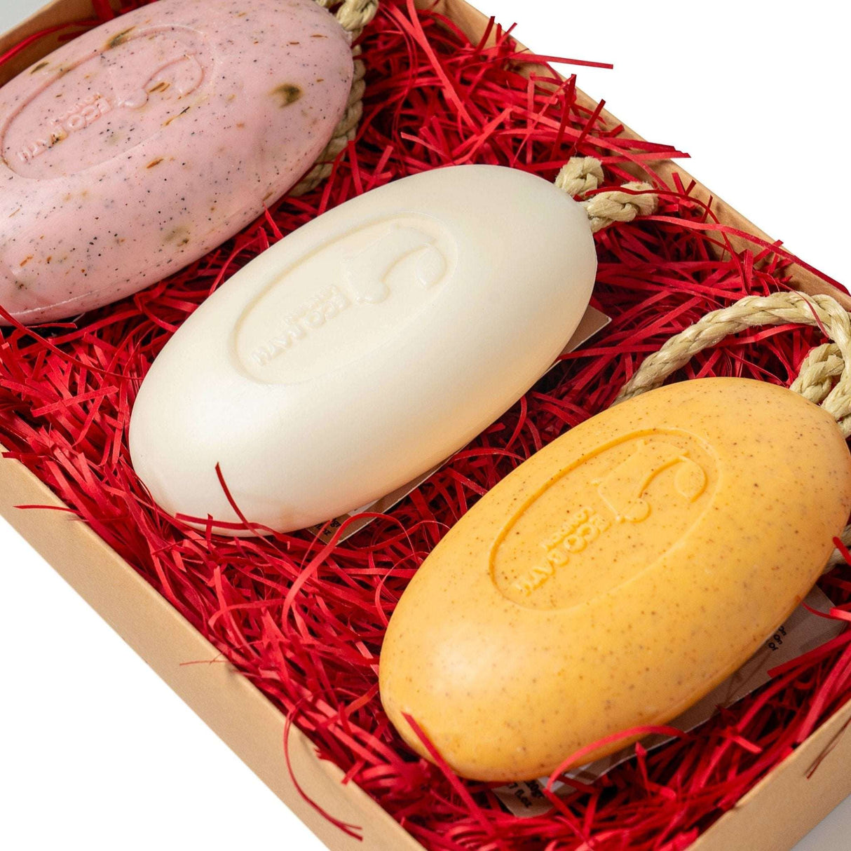 Eco Bath London Gift Box featuring three colourful Soap On A Rope bars nestled in red straw