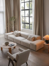 Modern Nisu Home sofa in neutral tones with cushions, enhancing a stylish living room interior