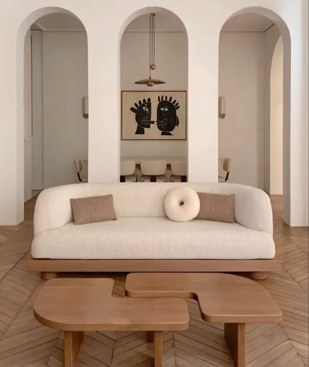 Stylish Nisu Home sofa in a modern living room with wooden coffee tables and minimalist decor