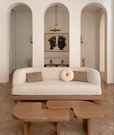 Stylish Nisu Home sofa in a modern living room with wooden coffee tables and minimalist decor