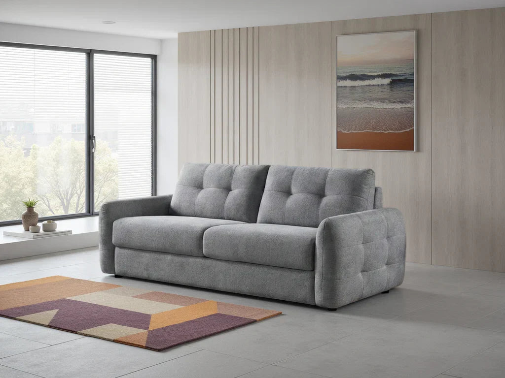 Modern grey sofabed with plush cushioning and tufted design, ideal for small living spaces