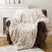 Soft beige and cream Nisu Home throw draped over a leather armchair for cozy home decor