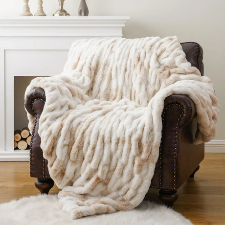 Soft beige and cream Nisu Home throw draped over a leather armchair for cozy home decor