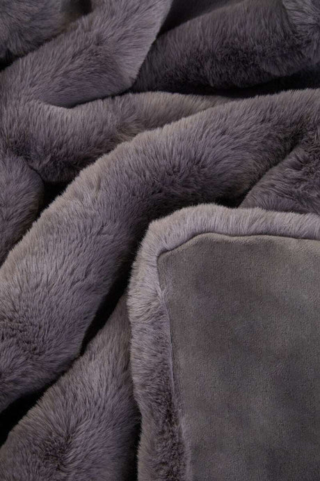 Soft and plush grey Orsina Fur Throw, perfect for adding warmth and style to any living space