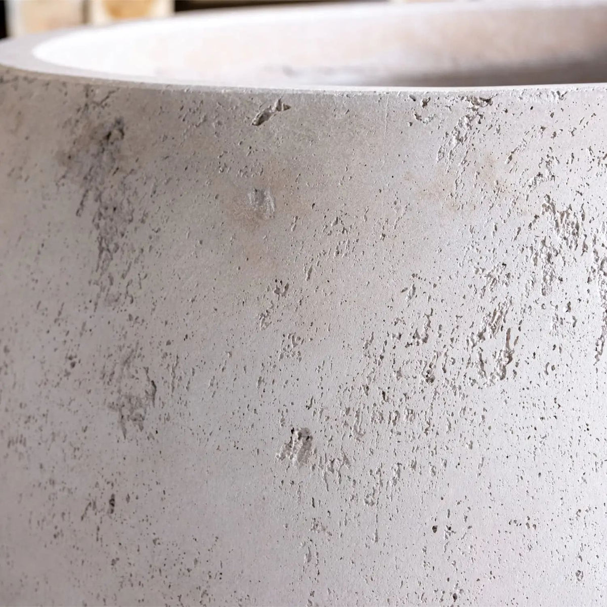 Close-up of a textured grey Sphere Planter from Jobu Home, perfect for indoor plants