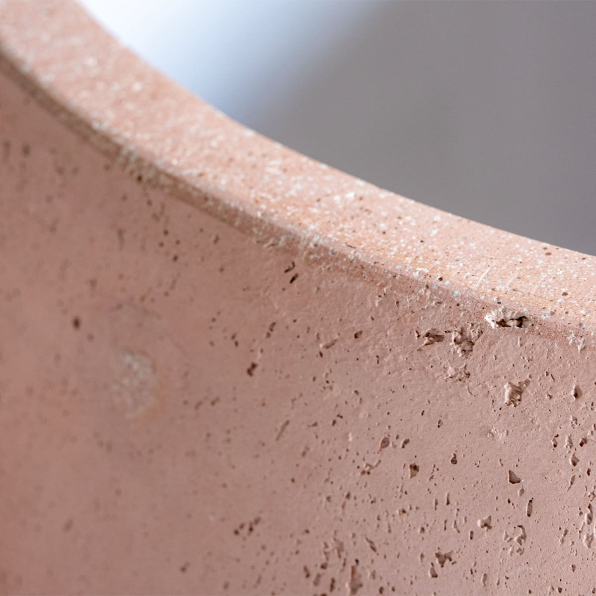 Close-up of Jobu Home Sphere Planter showcasing its textured, pink surface