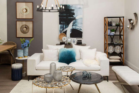 Orsina Square Cushion in vibrant teal on a stylish sofa in a modern living room setting