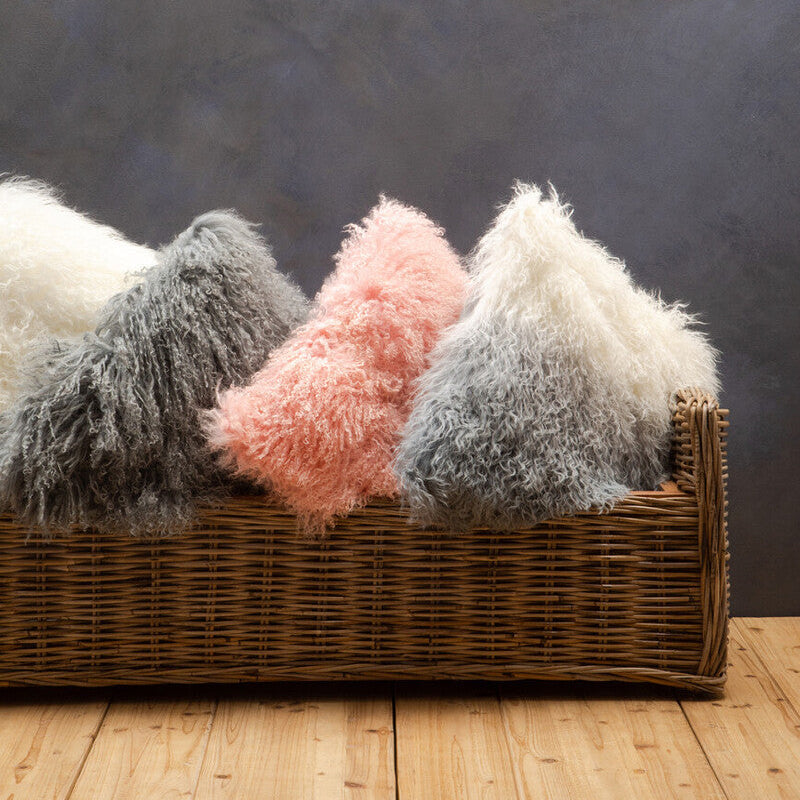 Orsina Square Cushion collection in soft textures and pastel colours arranged in a basket