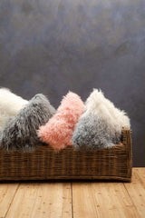 Orsina Square Cushion in various textures and colours arranged in a woven basket