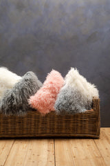 Orsina Square Cushion in various textures and colours arranged in a woven basket