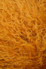 Orsina Square Cushion in warm orange, featuring a soft, fluffy texture for a cosy interior touch