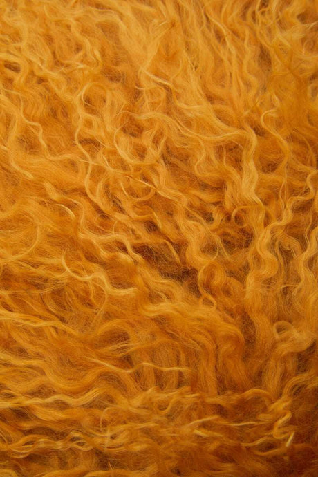 Orsina Square Cushion in warm orange, featuring a soft, fluffy texture for a cosy interior touch