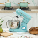 Wise Galleria Stand Mixer in teal with stainless steel bowl and whisk attachment on kitchen counter
