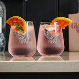 Selbrae House stemless glasses featuring a lion design with refreshing drinks and orange slices