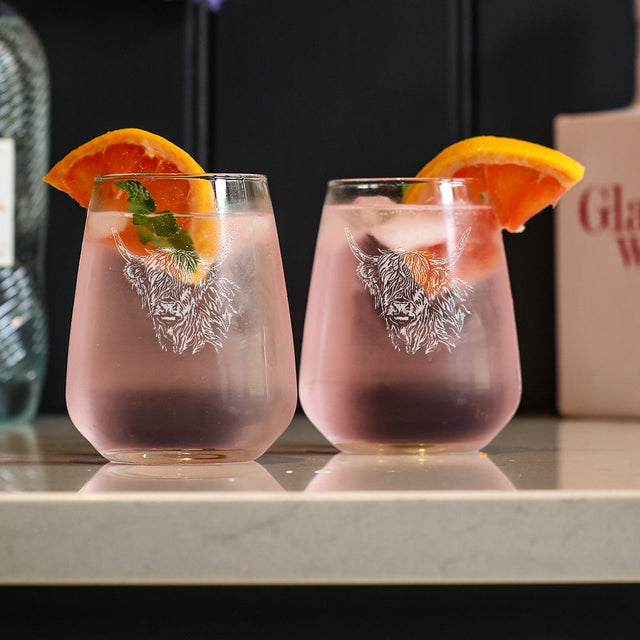 Selbrae House stemless glasses featuring a lion design with refreshing drinks and orange slices
