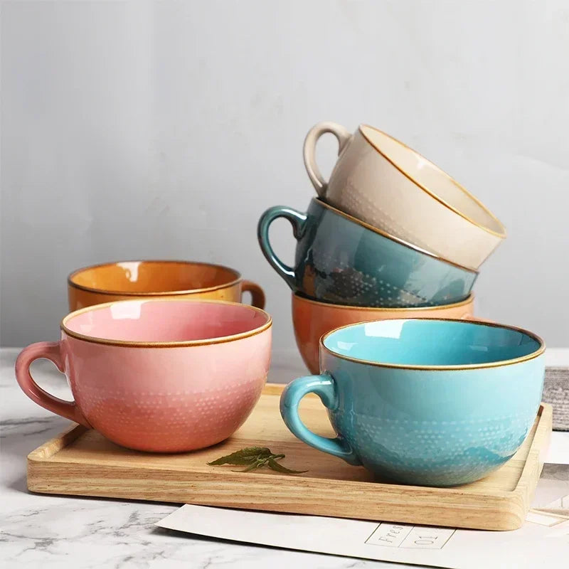 Set of Nisu Home Stoneware Cups in various colours on a wooden tray for stylish dining