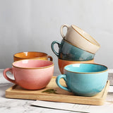 Set of Nisu Home Stoneware Cups in various colours on a wooden tray for stylish dining
