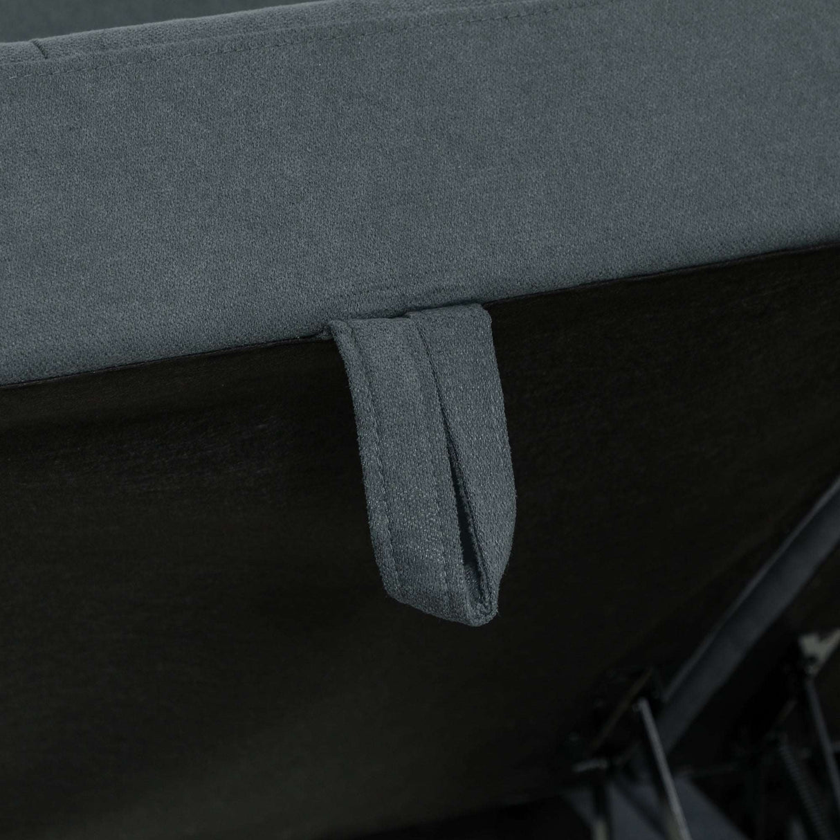 Close-up of a grey fabric Storage Sofa featuring a convenient handle for easy adjustment