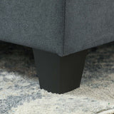 Close-up of the sturdy leg of a Wise Galleria Storage Sofa on a textured rug