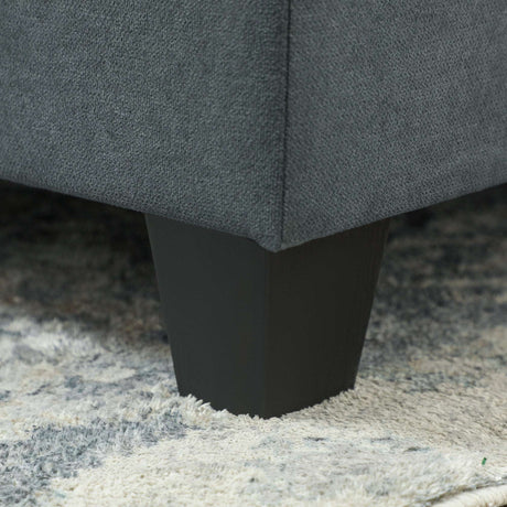Close-up of the sturdy leg of a Wise Galleria Storage Sofa on a textured rug