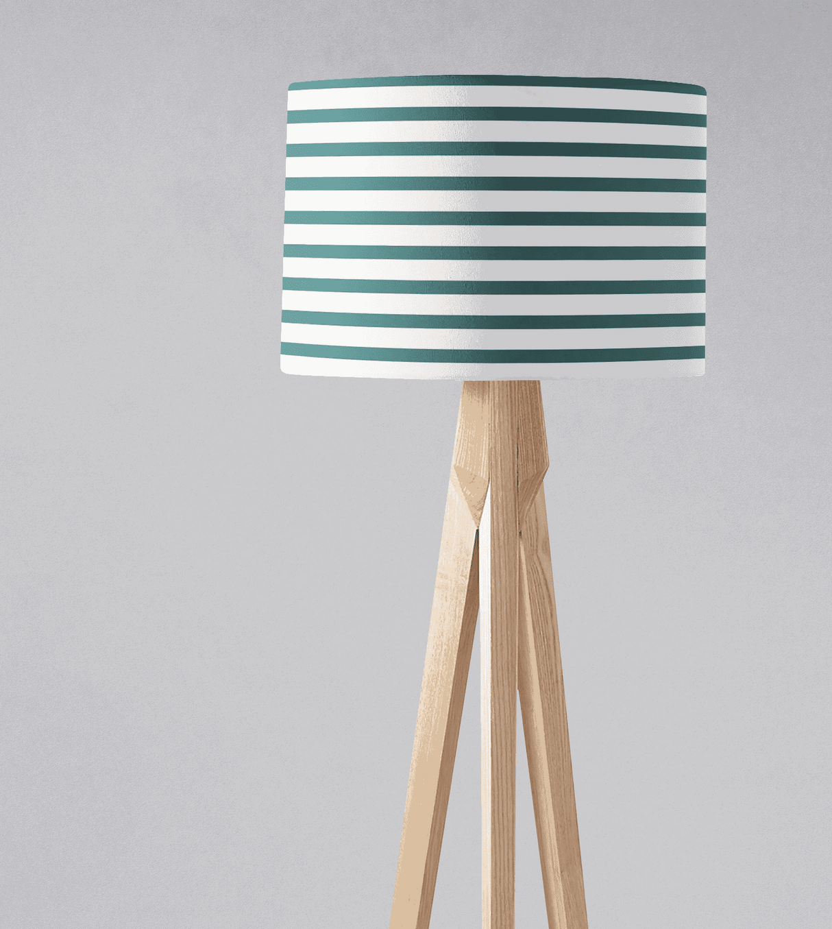 Shadow Bright lampshade with teal and white striped design on a wooden tripod lamp