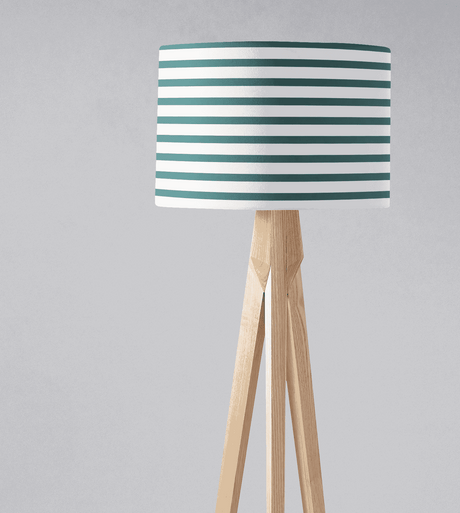 Shadow Bright lampshade with teal and white striped design on a wooden tripod lamp