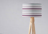 Shadow bright lampshade with multicoloured stripes on a wooden tripod lamp base