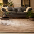 Elegant Striped Rug in a modern living room setting beneath a grey sofa with cushions