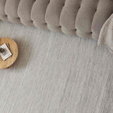 Neutral Striped Rug complementing a stylish sofa and wooden coffee table in a modern living room