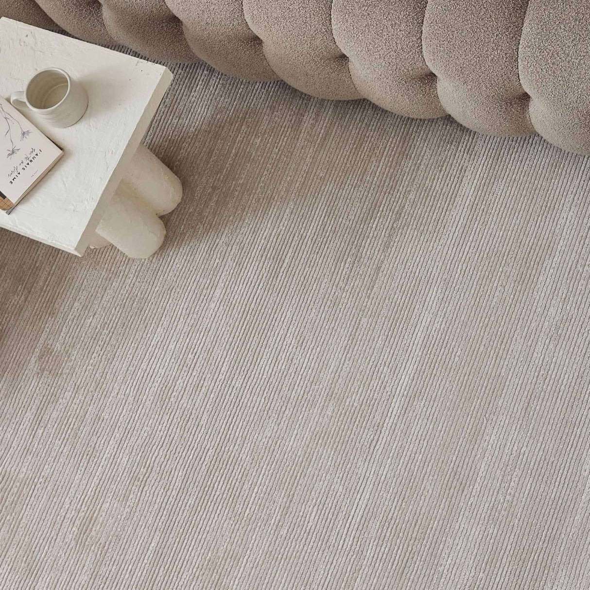 Neutral Striped Rug placed under a modern sofa, enhancing the contemporary living room decor