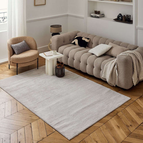 Neutral Striped Rug placed elegantly under a stylish sofa in a modern living room